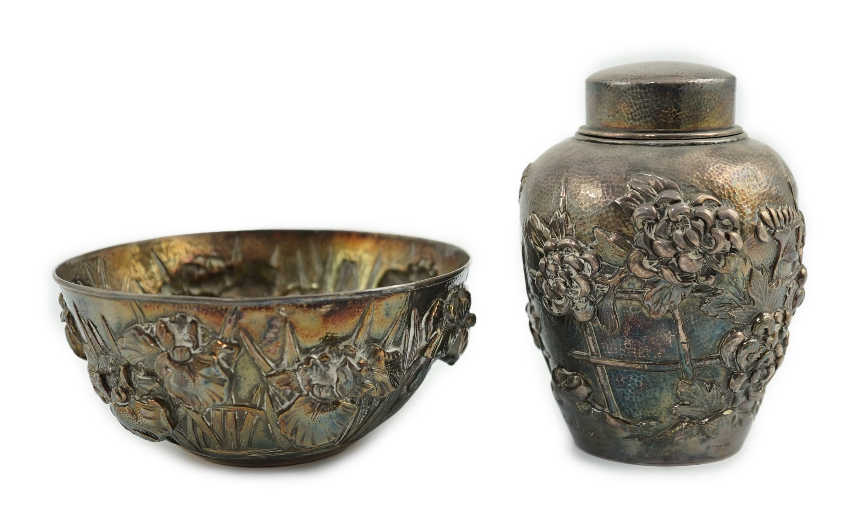 An early 20th century Japanese silver ovoid tea caddy and cover, decorated with prunus, together with a similar Japanese silver bowl